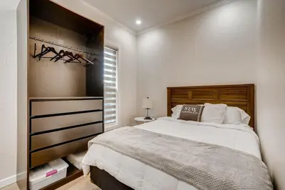 a bedroom with a large bed and a closet at 1020 E 24th Ave in Denver