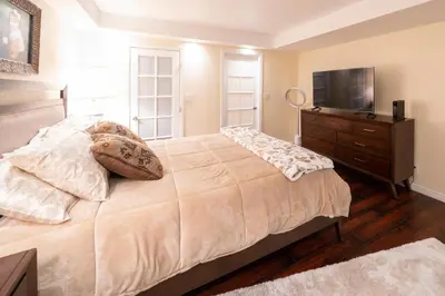 a bedroom with a bed with a television and a dresser at 1777 Larimer St #1911 in Denver