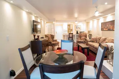 a living room with a glass table and chairs at 1777 Larimer St #1911 in Denver