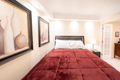 a bedroom with a bed with a red blanket at 1777 Larimer St #1911 in Denver