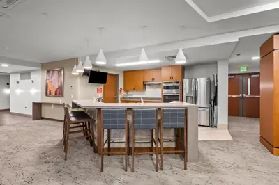 an open kitchen with a large island in the middle at 1777 Larimer St #903 in Denver