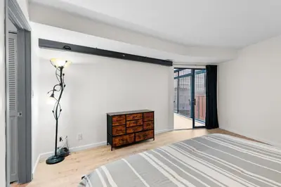 a bedroom with a bed and a dresser and a window at 1777 Larimer St #903 in Denver