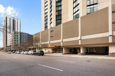 an empty street in front of a large building at 1777 Larimer St #903 in Denver