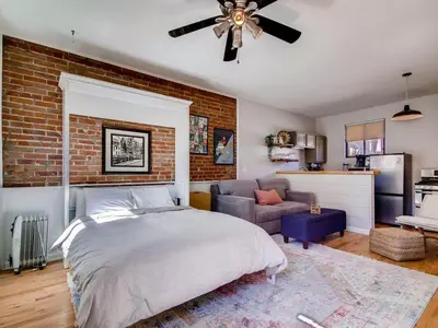 a bedroom with a bed and a brick wall at 3329 W 31st in Denver