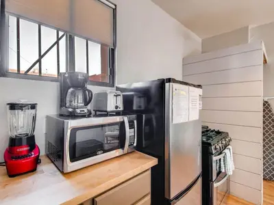 a kitchen with a microwave and a refrigerator at 3329 W 31st in Denver
