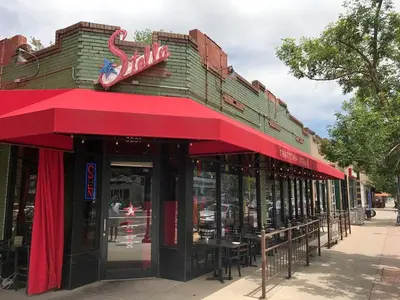 a restaurant with a red awning on a street at 3329 W 31st in Denver