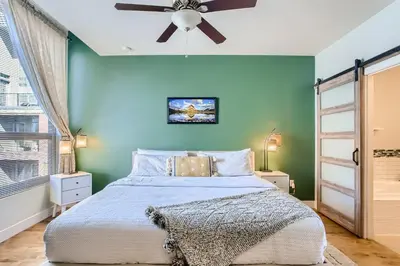 a bedroom with a large bed with a ceiling fan at 2900 Inca St 20 in Denver