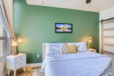 a bedroom with a bed with a green wall at 2900 Inca St 20 in Denver