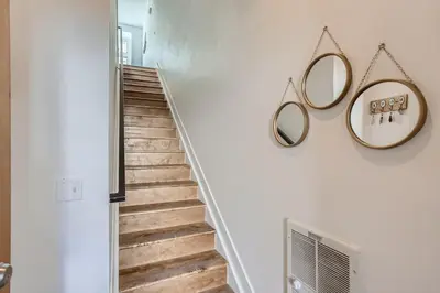 a staircase with two mirrors on the wall at 2900 Inca St 20 in Denver