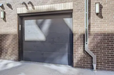 a black garage door on a brick building at 2900 Inca St 20 in Denver