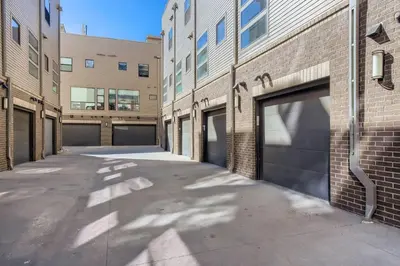 an empty alley between two buildings with garage doors at 2900 Inca St 20 in Denver