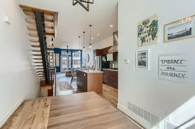 a kitchen and living room with a wooden table at 2900 Inca St 20 in Denver