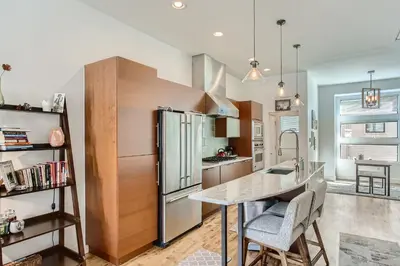 a kitchen with a refrigerator and a table with chairs at 2900 Inca St 20 in Denver