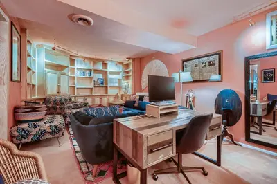 a living room with a desk and a couch at 1374 S Pennsylvania St in Denver