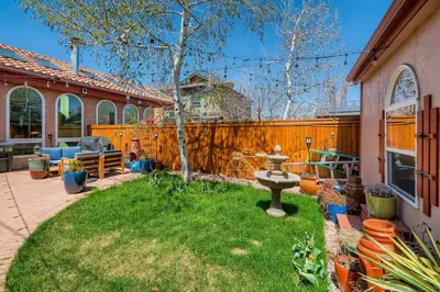 a backyard with a fountain and a fence at 1374 S Pennsylvania St in Denver
