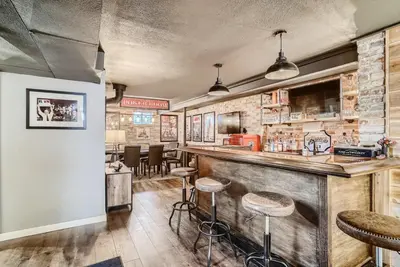 a bar in a restaurant with stools at 5235 E Atlantic Pl in Denver