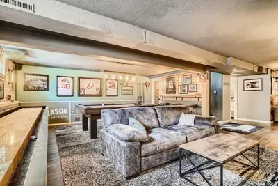 a living room with a couch and a table at 5235 E Atlantic Pl in Denver