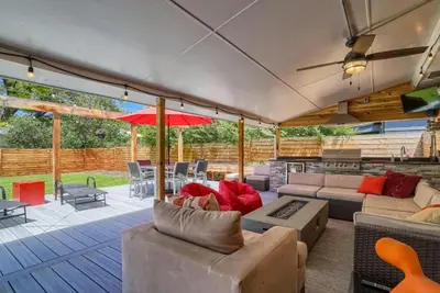 an outdoor patio with couches and an umbrella at 5235 E Atlantic Pl in Denver