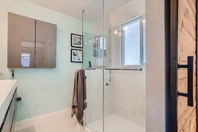 a bathroom with a shower with a glass door at 5235 E Atlantic Pl in Denver