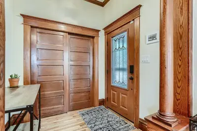 a room with a wooden door and a table at 113 4th Ave in Longmont