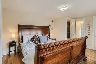 a bedroom with a large bed with a wooden headboard at 113 4th Ave in Longmont