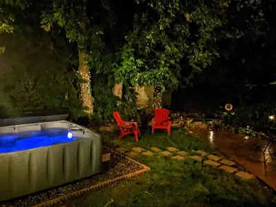 two red chairs and a hot tub at night at 113 4th Ave in Longmont
