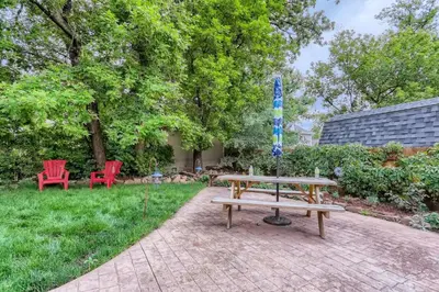 a picnic table and two red chairs in a yard at 113 4th Ave in Longmont