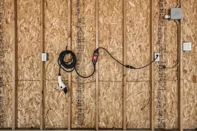 a wall with a wire hooked up to a socket at 113 4th Ave in Longmont