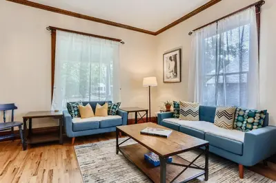 a living room with blue couches and a table at 113 4th Ave in Longmont