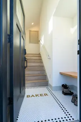 a hallway with a black and white tiled floor at 139 West Ellsworth in Denver