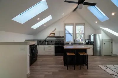 a kitchen with a vaulted ceiling with skylights at 139 West Ellsworth in Denver