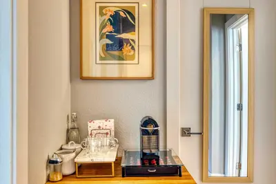 a room with a glass table and a picture on the wall at Walk to Empower Field Townhome with Hot Tub! in Denver