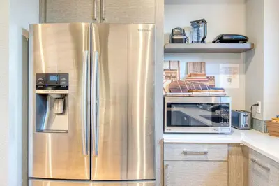 a stainless steel refrigerator in a kitchen at Walk to Empower Field Townhome with Hot Tub! in Denver