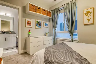 a bedroom with a bed and a window at Walk to Empower Field Townhome with Hot Tub! in Denver