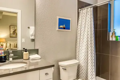 a bathroom with a toilet and a sink and a shower at Walk to Empower Field Townhome with Hot Tub! in Denver