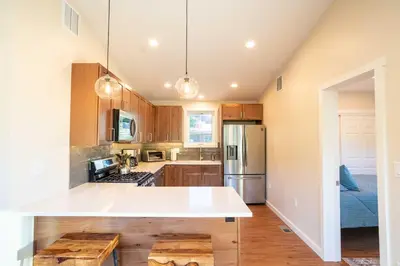 a kitchen with a white counter top in a room at Golden Cottage Near Red Rocks and School of Mines! in Golden