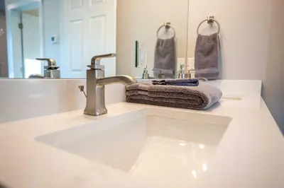 a bathroom counter with a sink and a mirror at Golden Cottage Near Red Rocks and School of Mines! in Golden