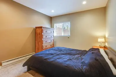 a bedroom with a bed and a dresser and a window at 15 Mi to Slopes Silverthorne Getaway! in Silverthorne