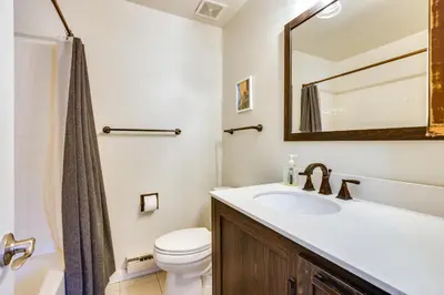 a bathroom with a sink and a toilet and a mirror at 15 Mi to Slopes Silverthorne Getaway! in Silverthorne