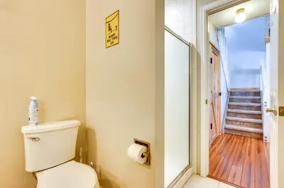 a bathroom with a toilet and a staircase at 15 Mi to Slopes Silverthorne Getaway! in Silverthorne