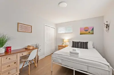 a bedroom with a desk and a bed in a room at Modern Retreat With Patio & Sunset Views - Gray St in Arvada