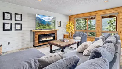 a living room with a couch and a fireplace at Alpenglow Vacation Home at Windcliff home in Estes Park