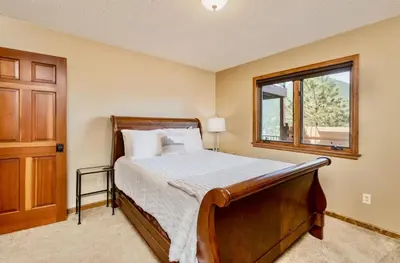 a bedroom with a bed and a window at Alpenglow Vacation Home at Windcliff home in Estes Park