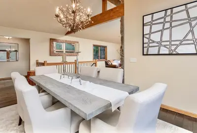 a dining room with a table and white chairs at Alpenglow Vacation Home at Windcliff home in Estes Park