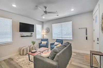 a living room with a couch and a tv at Gorgeous Greeley Getaway - Close to Parks! in Greeley