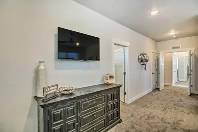a living room with a television on a wall at Gorgeous Greeley Getaway - Close to Parks! in Greeley