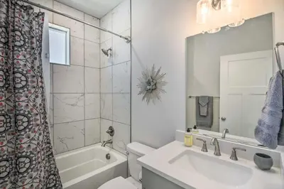 a bathroom with a sink and a toilet and a mirror at Gorgeous Greeley Getaway - Close to Parks! in Greeley