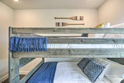 two bunk beds in a room with a bed at Gorgeous Greeley Getaway - Close to Parks! in Greeley