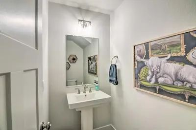 a bathroom with a sink and a mirror at Gorgeous Greeley Getaway - Close to Parks! in Greeley