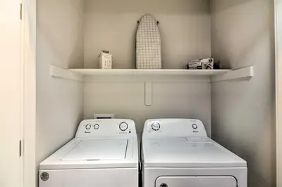 a laundry room with two washing machines and a shelf at Gorgeous Greeley Getaway - Close to Parks! in Greeley